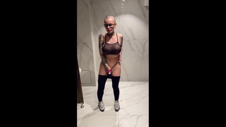 crazy slut bald doll squirting in male public urinal, slut with big tits